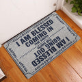 Christian entryway rug displayed by a white door on warm wood flooring with a leafy border design