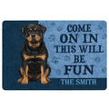 Rottweiler doormat with black and tan dog artwork and a bold welcome message in blue and black