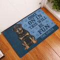 Rottweiler welcome doormat styled in a home entryway on a warm wood floor beside a door