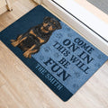 Blue and black Rottweiler entryway rug displayed beside a doorway with a bold welcoming design