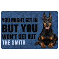 Blue Doberman doormat featuring a bold black warning message and a realistic seated dog portrait