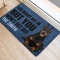 Doberman door mat placed beside a doorway with a bold blue and black dog-themed design
