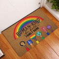 Rainbow LGBT entryway rug displayed in front of a white door on a wood floor