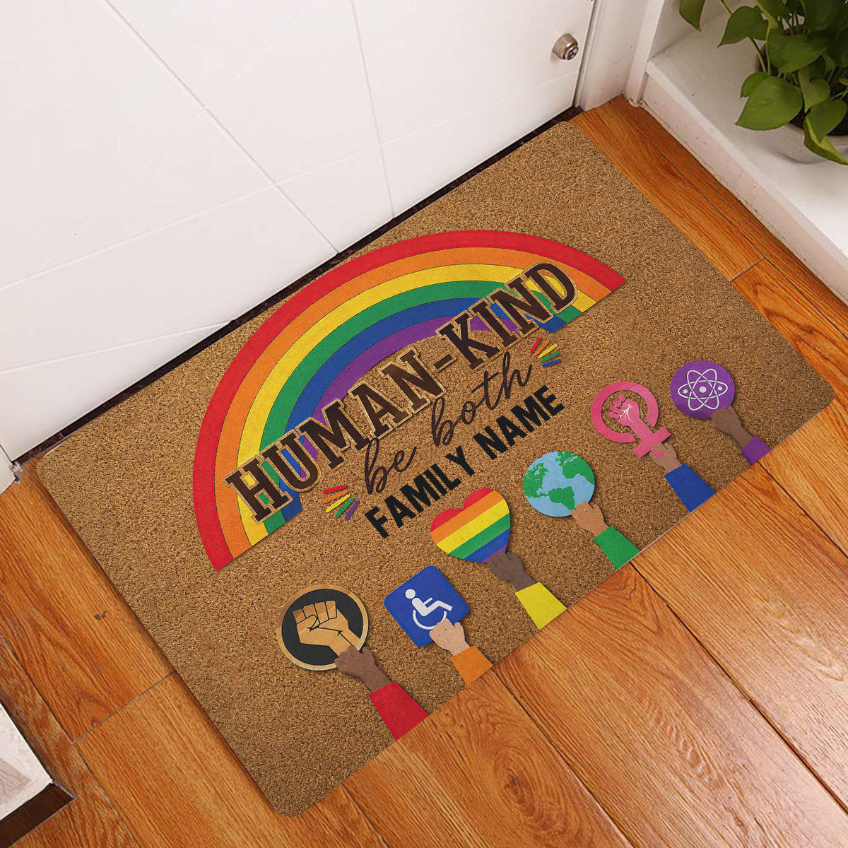 Rainbow LGBT entryway rug displayed in front of a white door on a wood floor