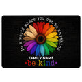 Black LGBT doormat with a colorful rainbow flower and inclusive kindness message