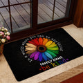 Rainbow flower LGBT doormat shown in a welcoming doorway with wood and glass doors