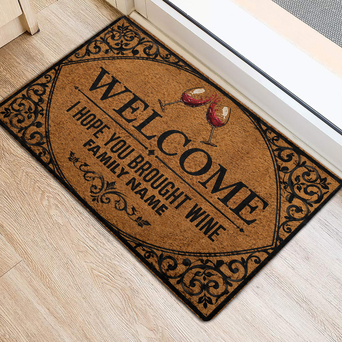 Wine welcome door mat with red wine glasses and ornate scrollwork beside an interior doorway