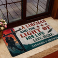 Lineman doormat displayed inside a glass entry door with rustic utility-themed artwork