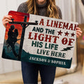 Lineman door mat held indoors, showing the utility worker and colorful rustic design