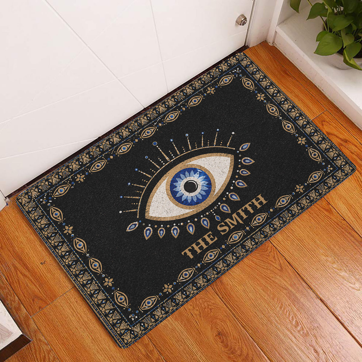 Evil eye entryway rug displayed beside a white door on a warm wood floor