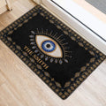 Blue and gold evil eye door mat styled inside a bright home entrance