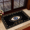 Ornate evil eye doormat placed near a glass door in a welcoming entryway