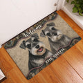 Miniature Schnauzer welcome doormat displayed at an indoor entryway on a warm wood floor