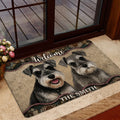 Miniature Schnauzer welcome mat styled inside a glass doorway with two portrait-style dog illustrations