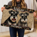 Miniature Schnauzer doormat held indoors, showing two expressive dogs, welcome lettering, and decorative artwork