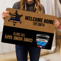 Person holding a police-themed welcome doormat with badge and patrol vehicle artwork