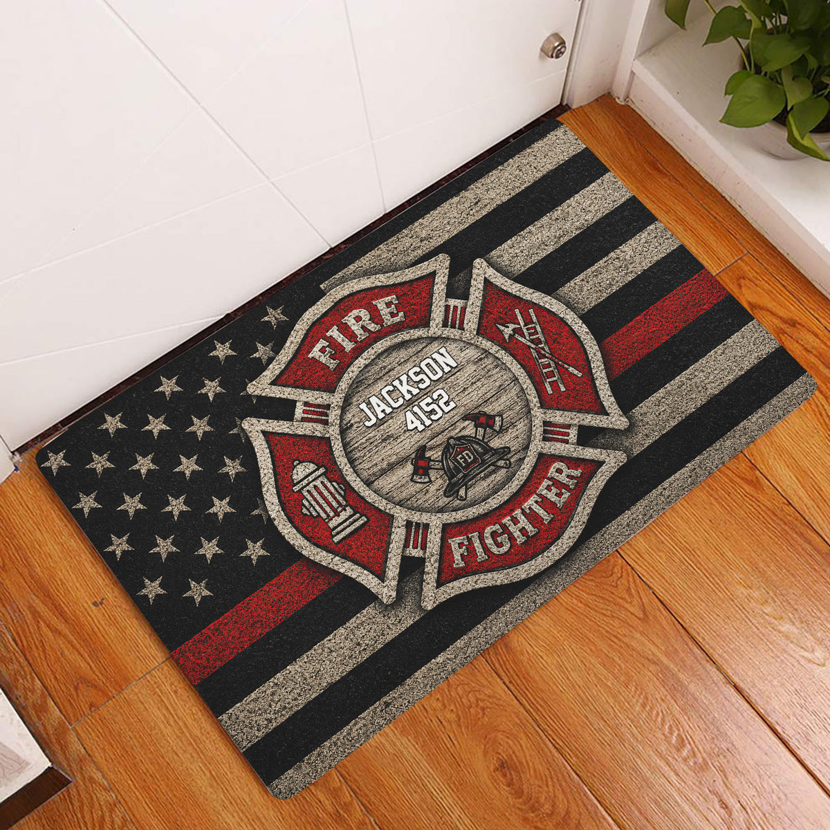 Firefighter entryway doormat displayed on a wood floor beside a white door