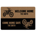 Motocross doormat featuring dirt bike illustrations, bold welcome messaging, and tan and black artwork