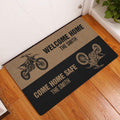 Motocross entryway doormat displayed on a wood floor with dirt bike graphics and welcome messaging