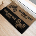 Motocross door mat positioned at an entryway, featuring dirt bikes and bold welcome home artwork