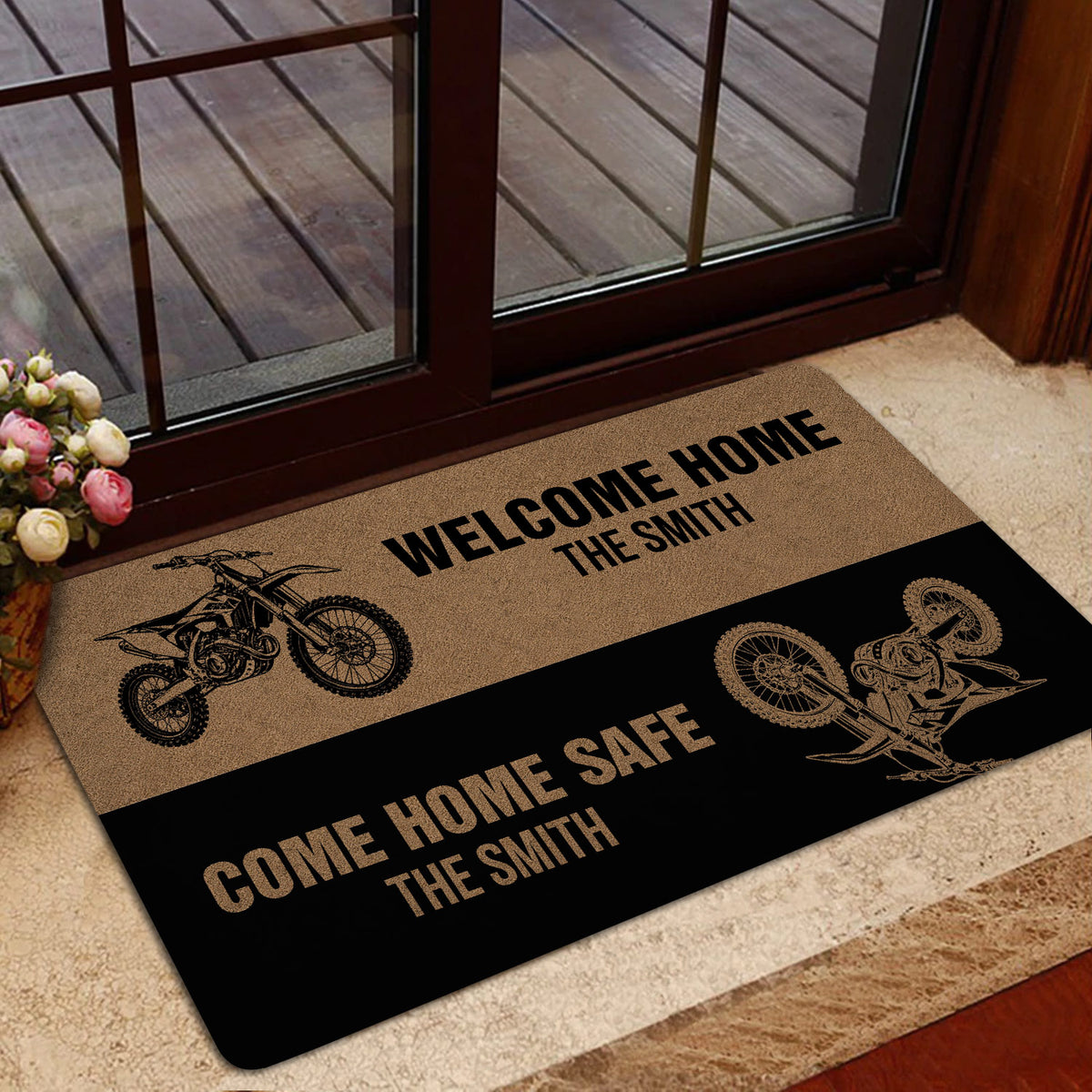 Motocross doormat styled beside a glass entry door with dirt bike illustrations and black and tan design