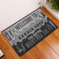 Barber shop doormat displayed in a bright entryway on a wood floor beside a door