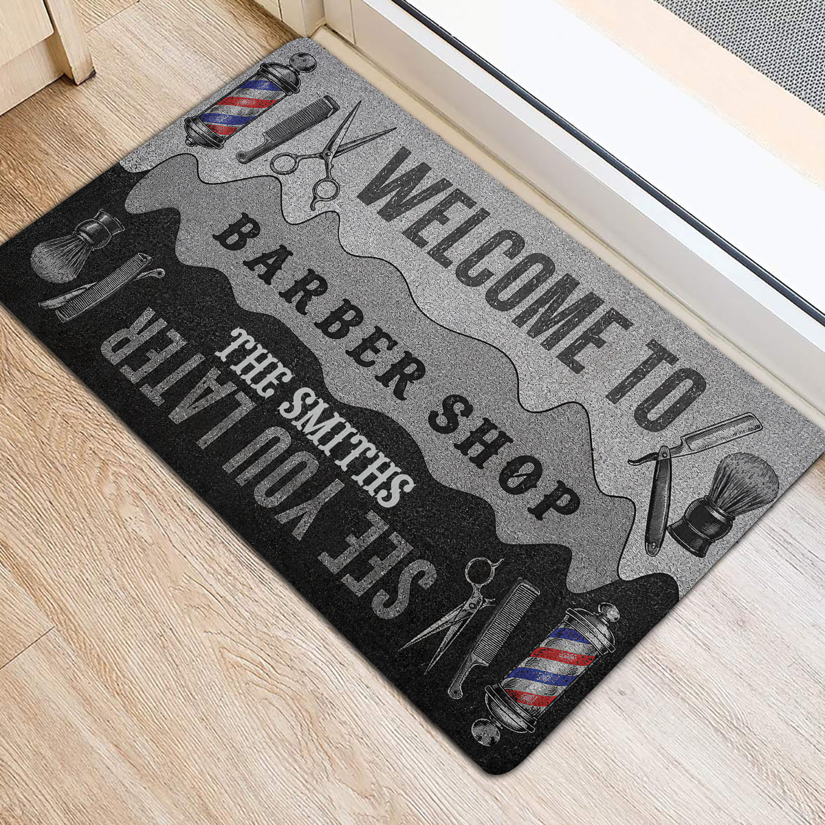 Hairdresser-themed entryway mat with barber tools and bold welcome artwork beside a doorway