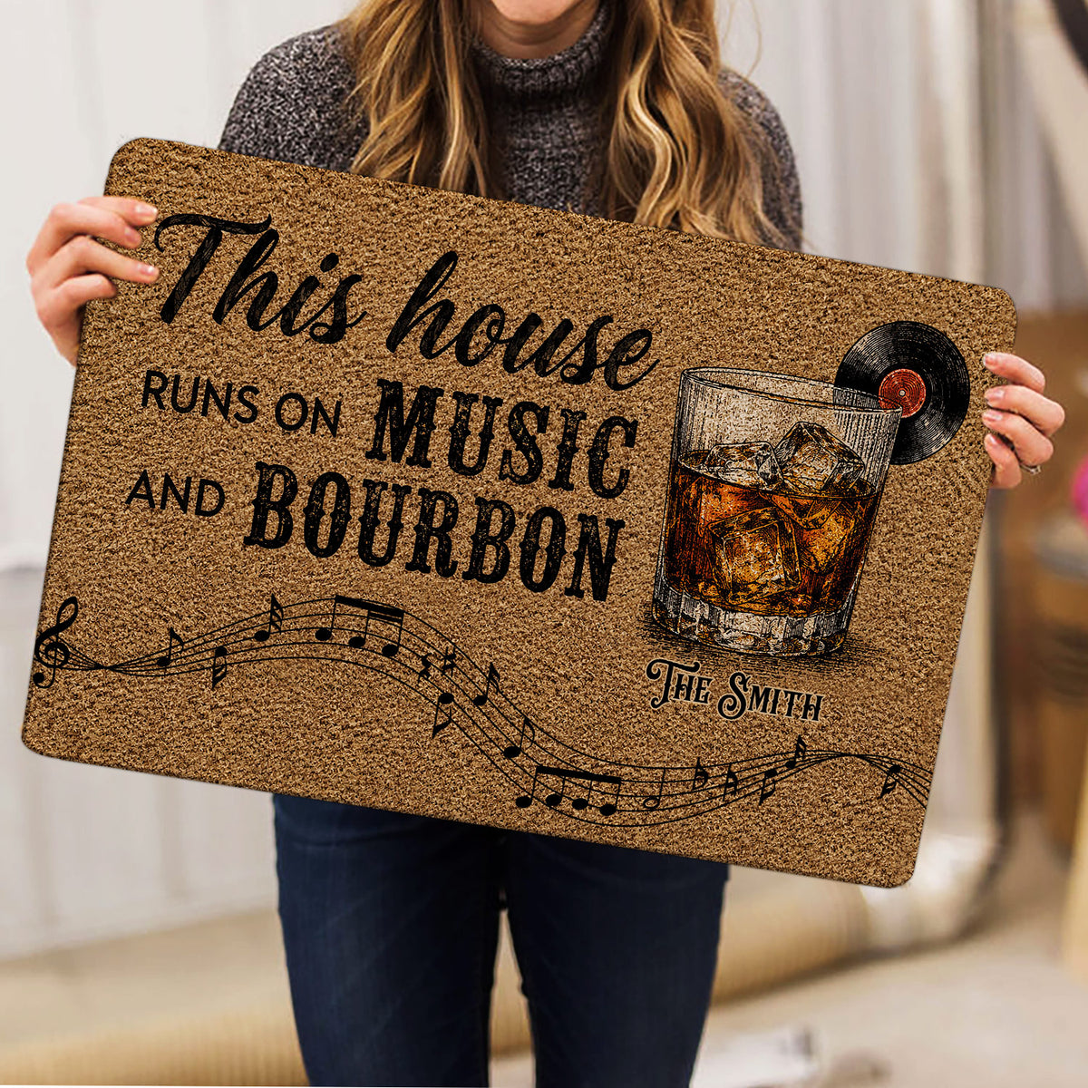 Bourbon-themed entryway mat held indoors, featuring whiskey, record, and music artwork