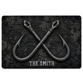 Black fishing doormat featuring crossed vintage-style hooks and a textured nautical background