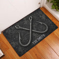 Fishing hook doormat styled in a home entryway on a warm wood floor