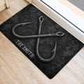 Fishing-themed doormat placed beside a doorway with crossed hook artwork