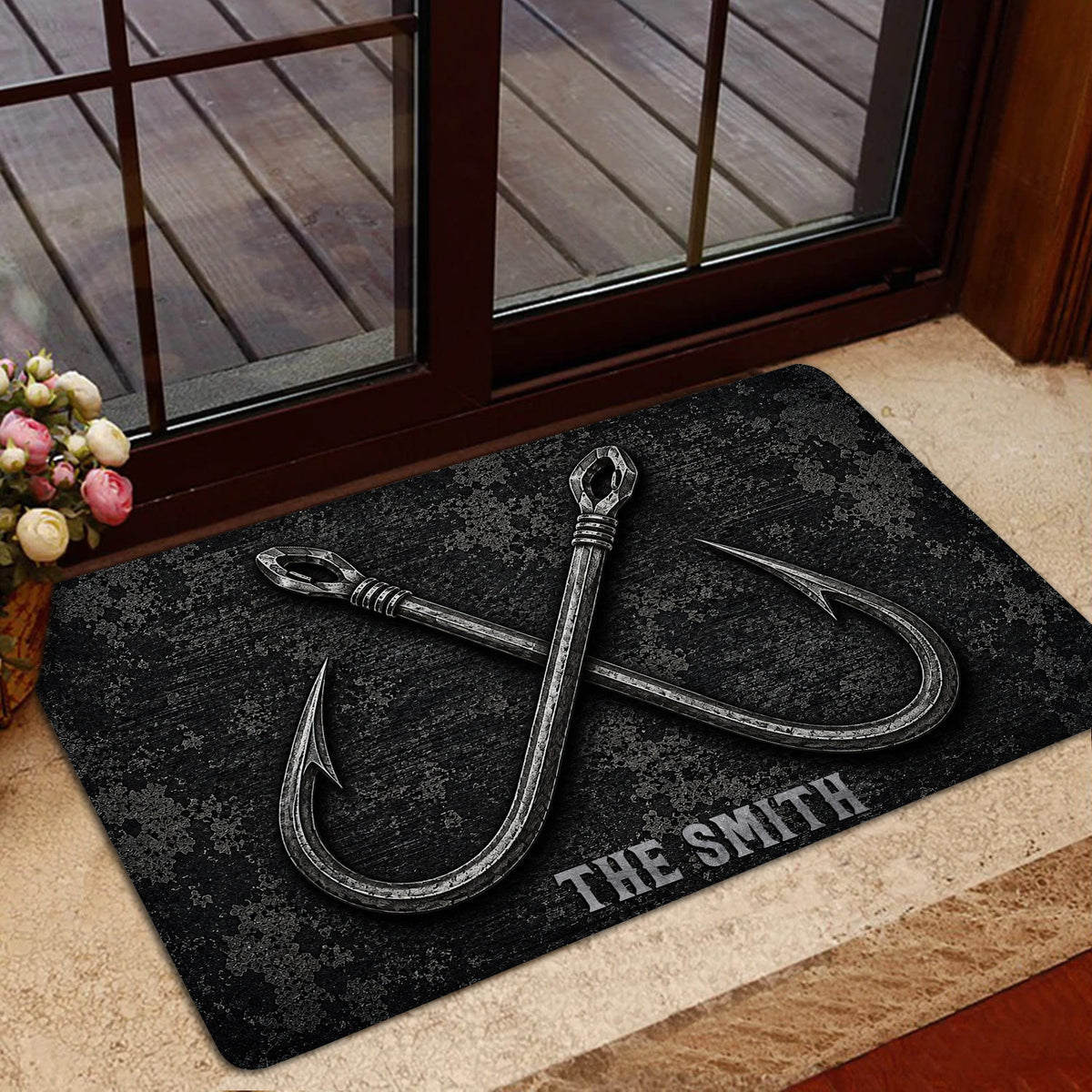 Black fishing doormat displayed in a home entrance with crossed hook artwork