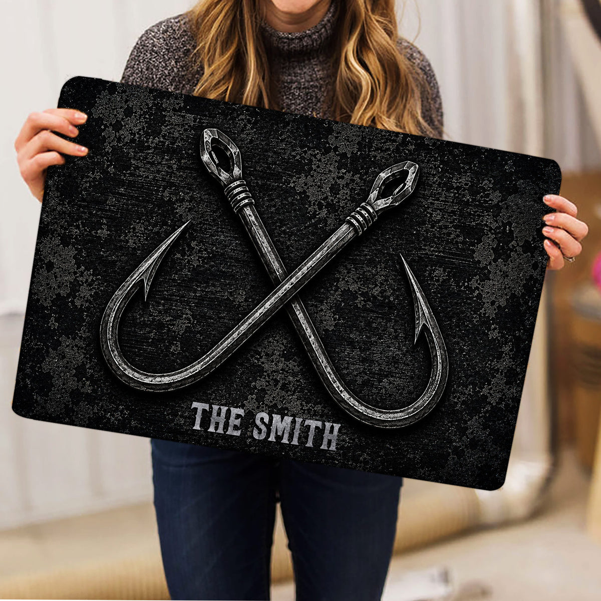 Fishing hook doormat held up indoors to show its full dark nautical design
