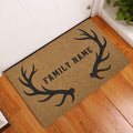 Antler hunting doormat displayed at a home entrance on a warm wood floor