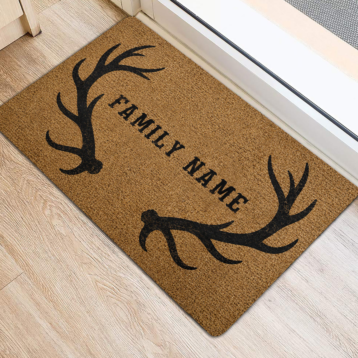 Hunting-themed entryway rug with black antlers and family lettering near a doorway