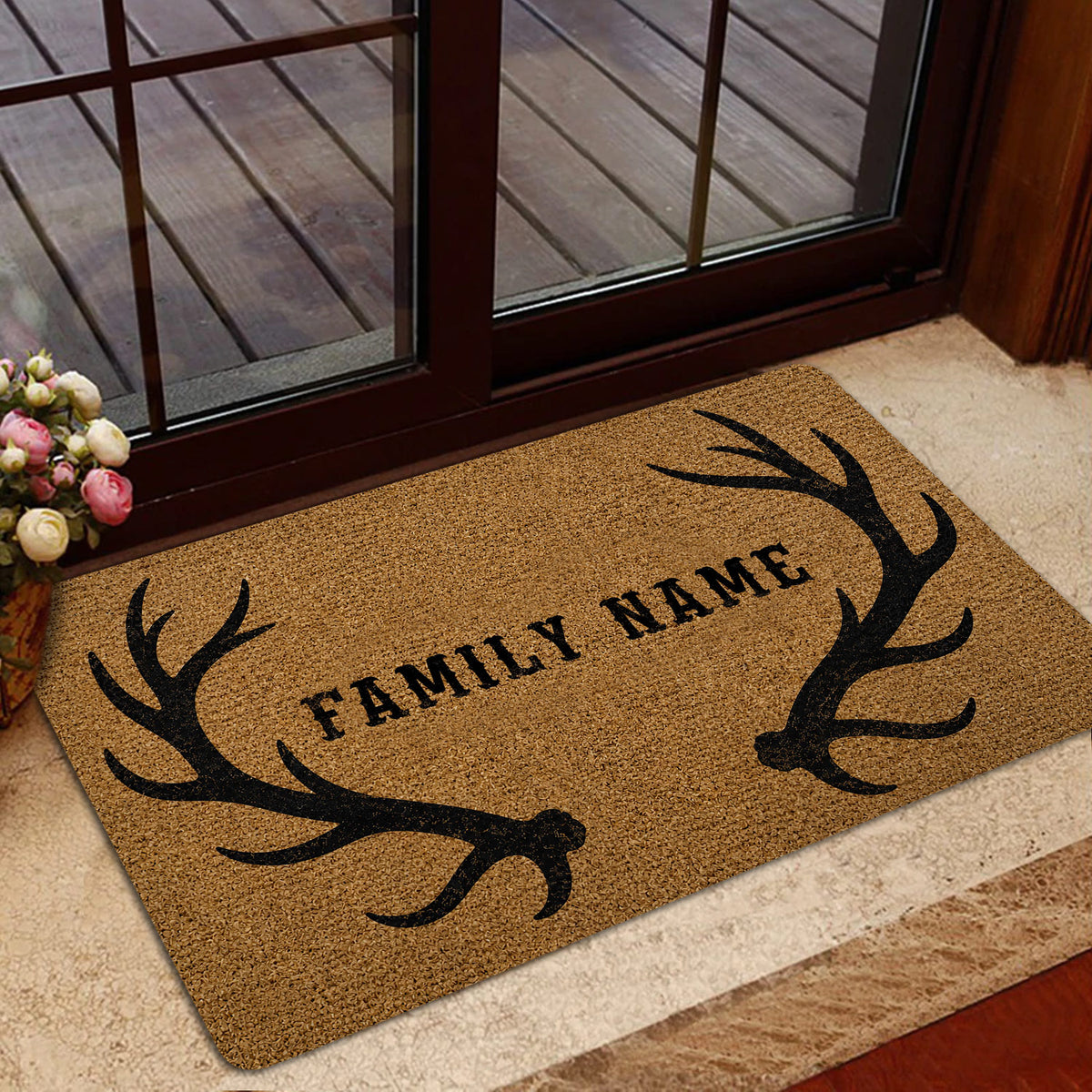 Rustic antler doormat styled inside a glass doorway with a warm home entryway setting