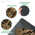 Camping doormat detail showing the printed felt surface and black rubber backing with a close-up view