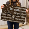 Hunting doormat held indoors, showing an antlered deer skull and distressed patriotic-style artwork