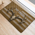 Rustic deer skull and antler hunting doormat positioned near an indoor doorway on light wood flooring