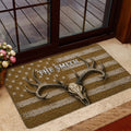 Hunting doormat with antlered skull artwork shown in a home entrance beside a glass door and wood deck