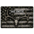 Hunting doormat with a deer skull and wide antlers over dark camouflage and distressed stripe artwork