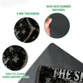 Close-up of hunting doormat artwork with a textured printed surface and dark rubber backing