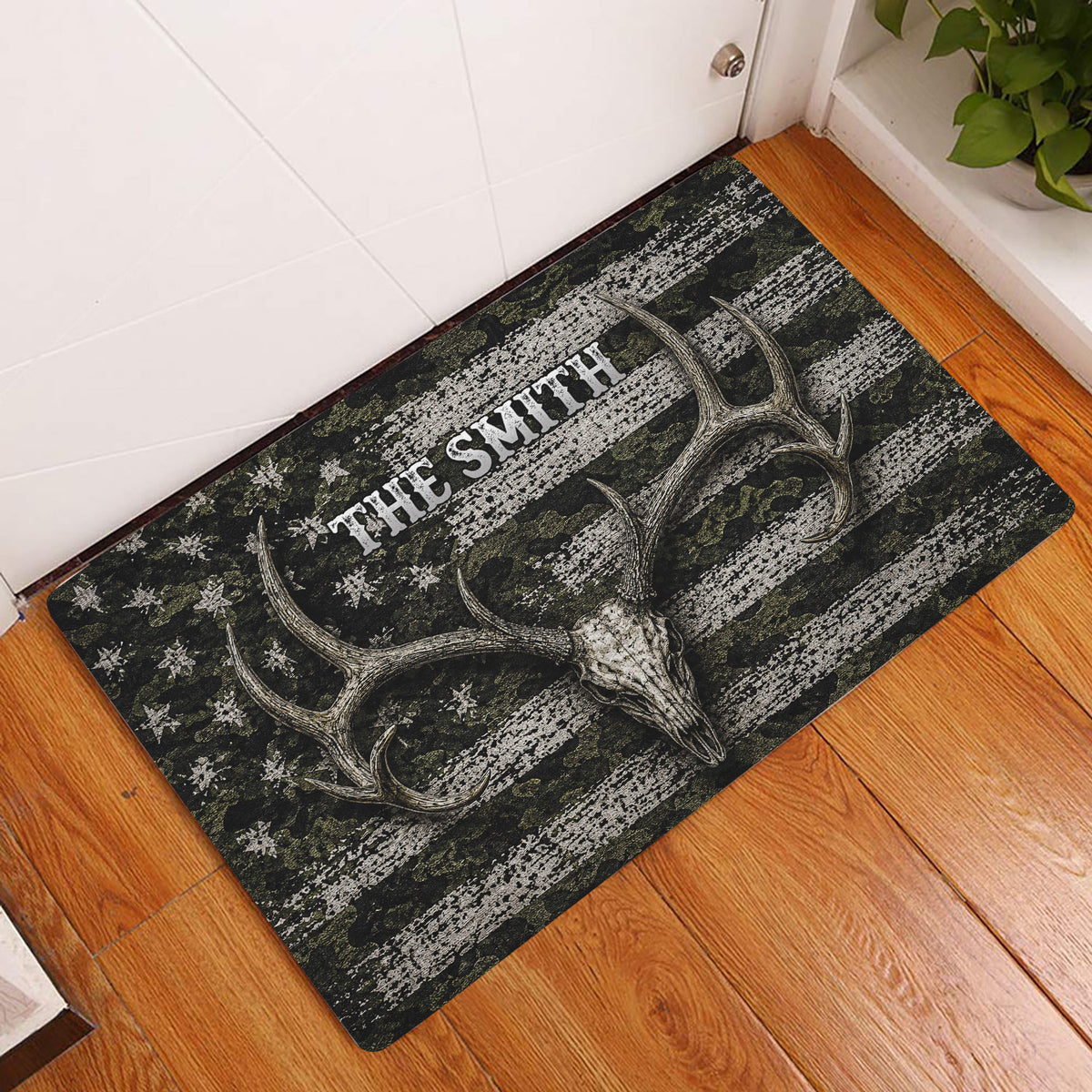 Hunting doormat displayed at an indoor entryway with deer skull and antler artwork