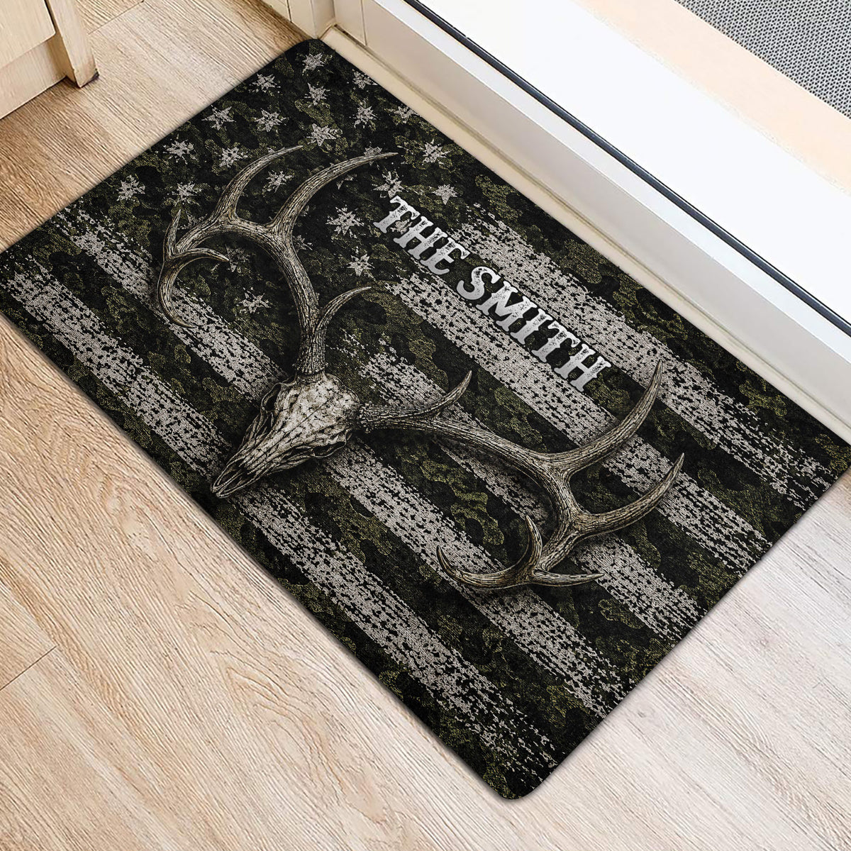 Deer skull hunting doormat positioned beside a doorway on a light wood floor