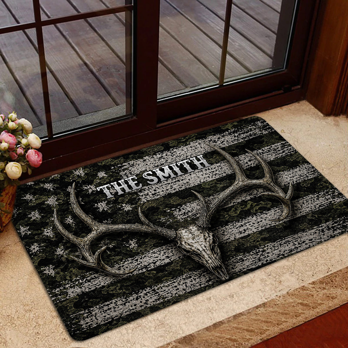 Hunting-themed doormat with antlers and skull artwork styled in a home entrance