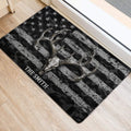 Hunting-themed deer skull and antler doormat placed inside a doorway on a light wood floor