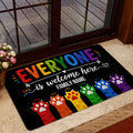 Rainbow LGBT welcome mat styled near a glass entrance door with colorful paw prints and inclusive artwork
