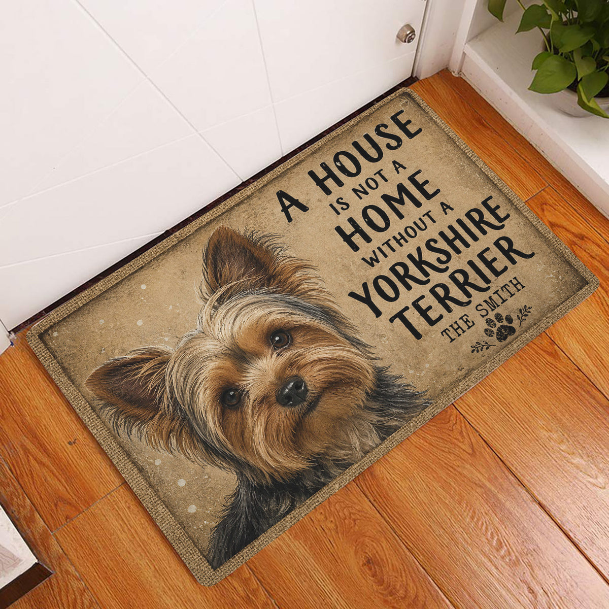 Yorkshire Terrier doormat styled inside a home entryway on a warm wood floor beside a white door
