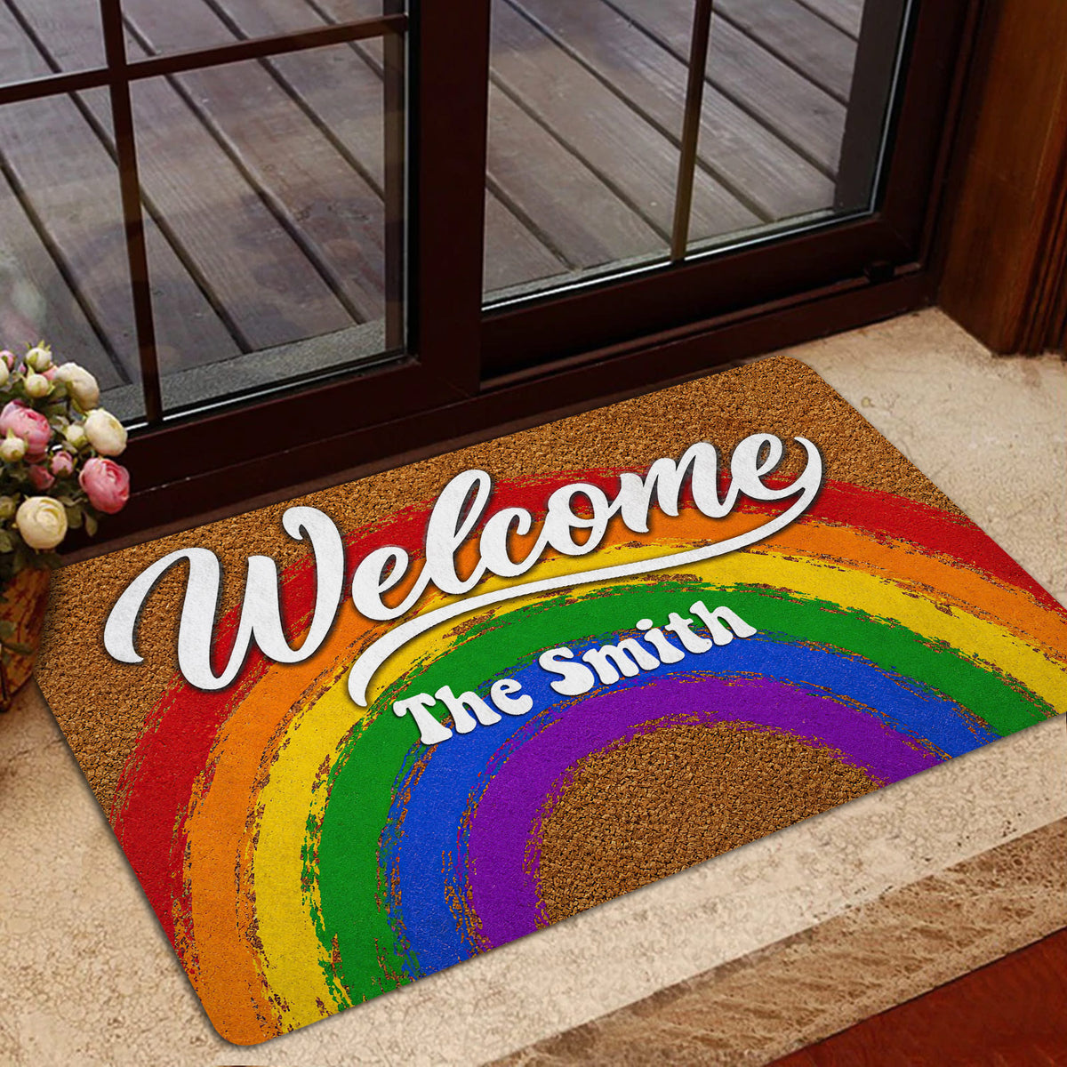 Rainbow Welcome entryway mat shown in a home entrance with glass doors