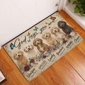 Goldendoodle entryway mat displayed beside a white door on a warm wood floor with floral and butterfly artwork